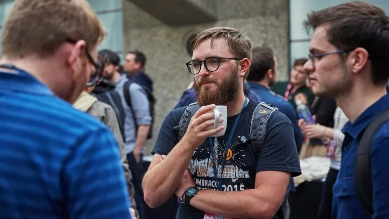 Joe Glombek stood with mug of coffee at Umbraco UK Festival